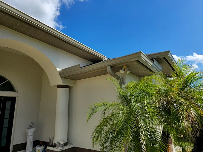 Technician performing trusted gutter repairs Naples FL on residential home
