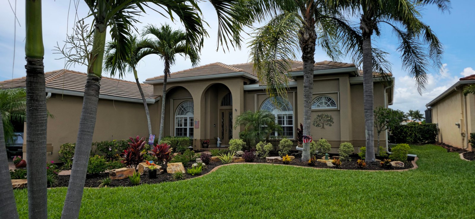 Technician performing trusted gutter repairs Naples FL on residential home