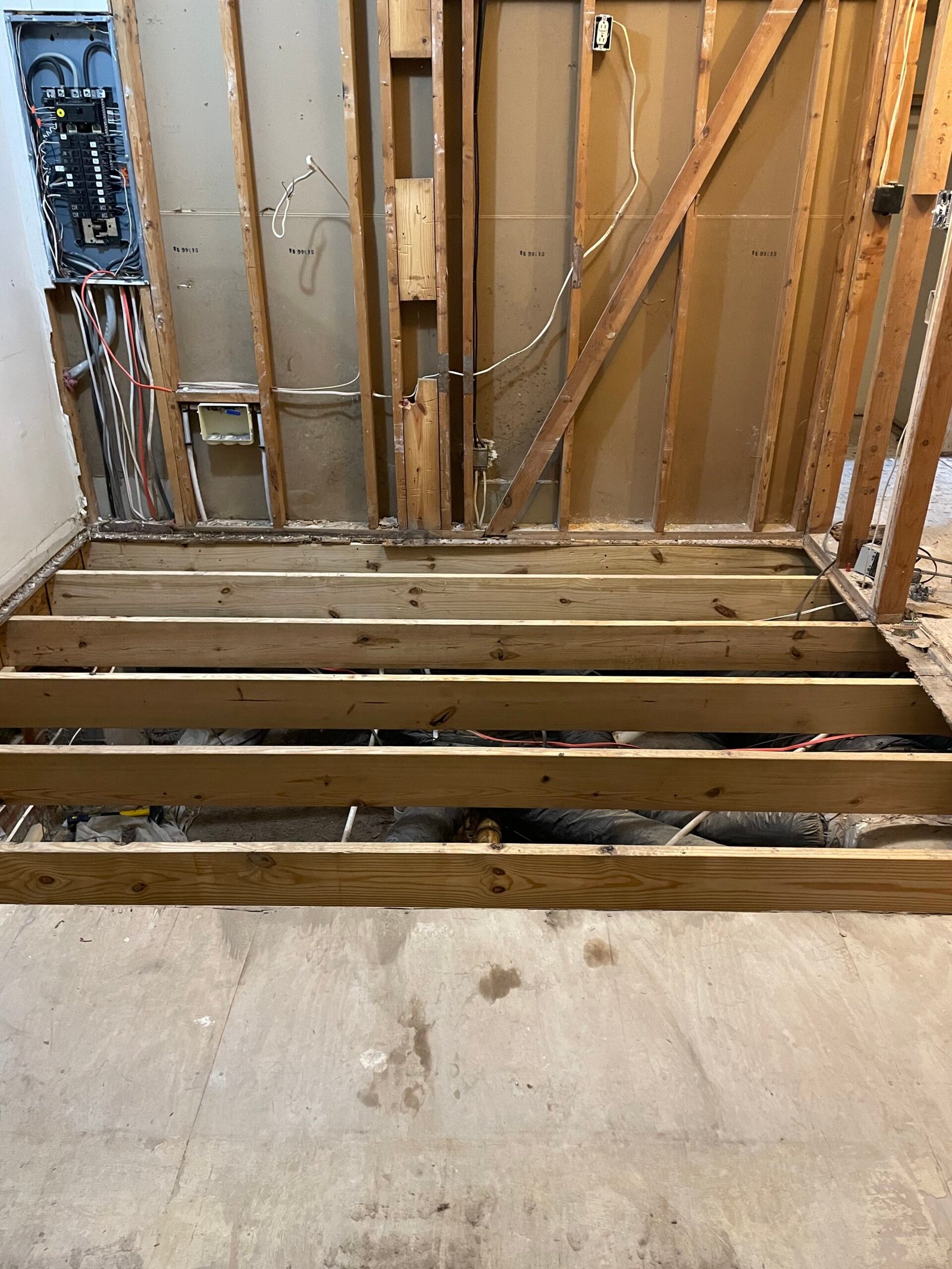 Foundation repair specialist measuring settlement and reviewing structural movement with professional tools