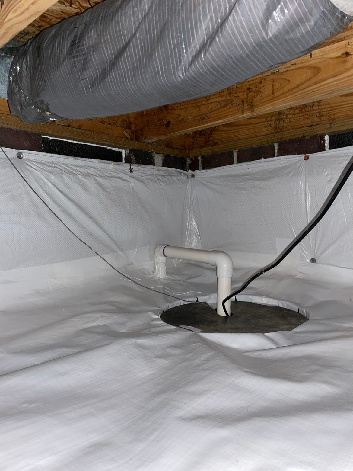 Technician checking wall cracks and floor slope in Central North Carolina home with settlement issues